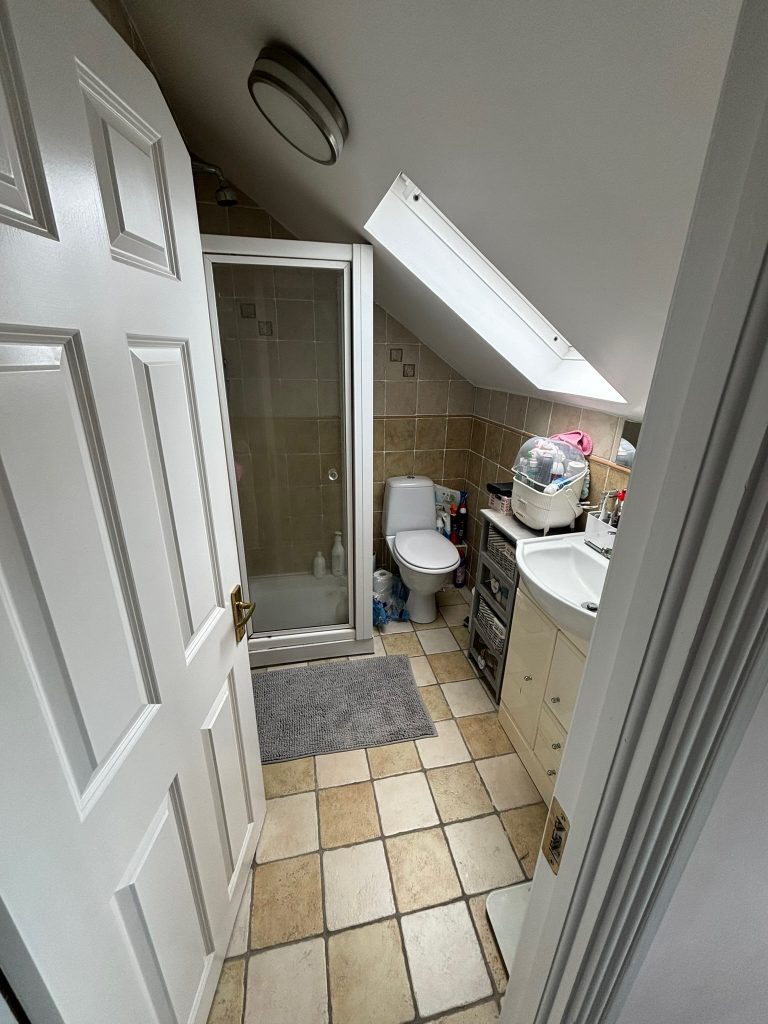 Before photo of tight attic ensuite bathroom in Clontarf with sloped ceiling