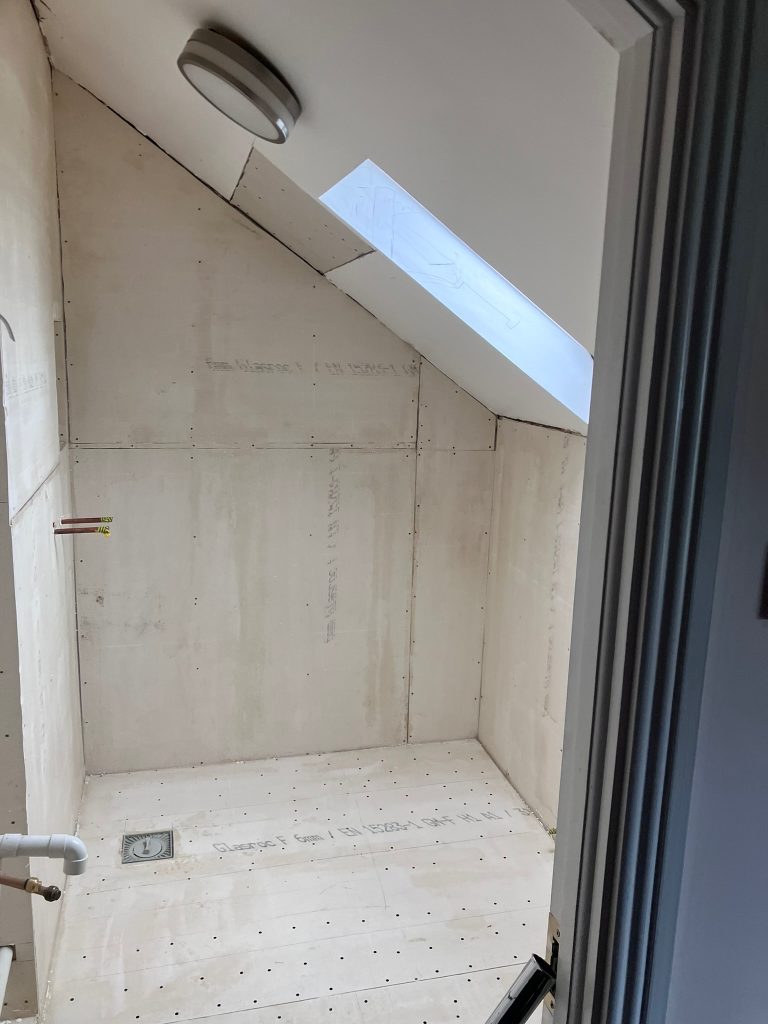 Attic ensuite wet room renovation in progress with wall preparation in Clontarf