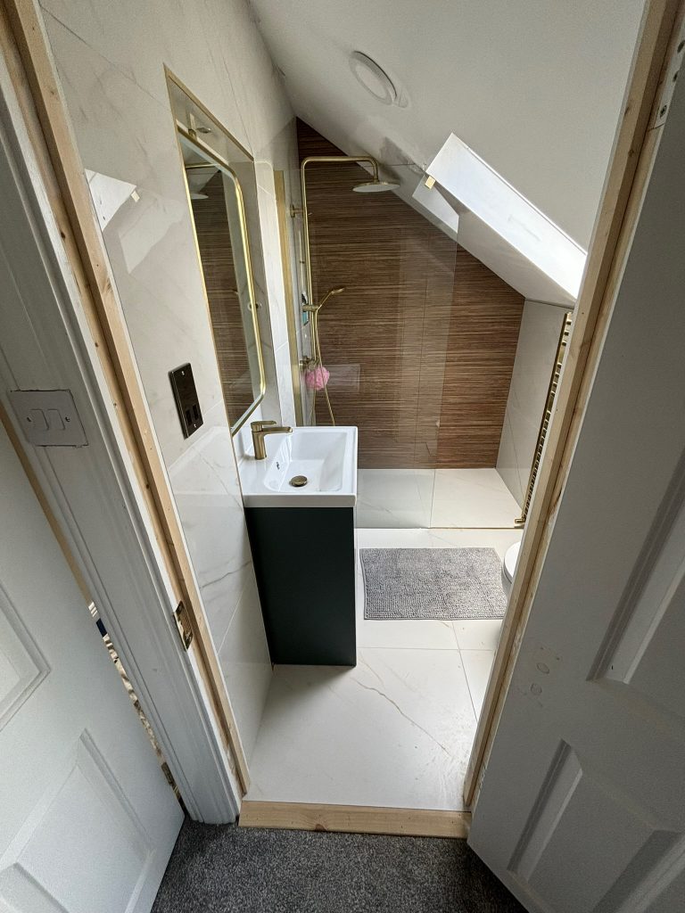 Finished attic ensuite wet room in Clontarf with recessed vanity and roof light