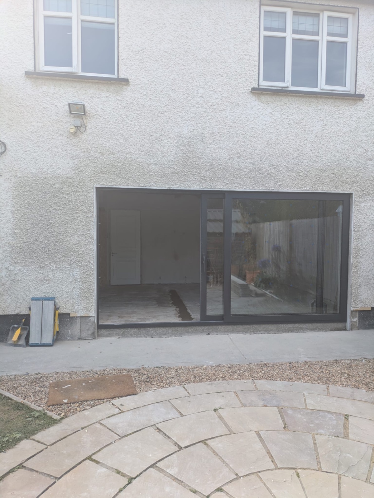 Finished rear wall after sliding door installation and exterior render repairs.